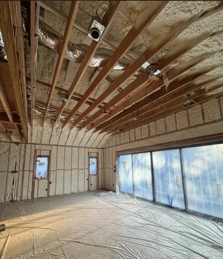 Interior walls and ceiling insulated with spray foam during new construction in Oyster Bay